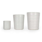 Three white ceramic 3D printed drinking cups, with a ridge pattern of different sizes on a white background