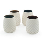 Four porcelain drinking cups with a stemless dot pattern, with a dark interior design on a white background