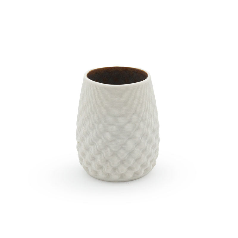 Porcelain drinking cup with a stemless dot pattern, with a dark interior design on a white background