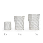 Three white textured 3D printed ceramic drinking cups with a wave twist pattern on a white background