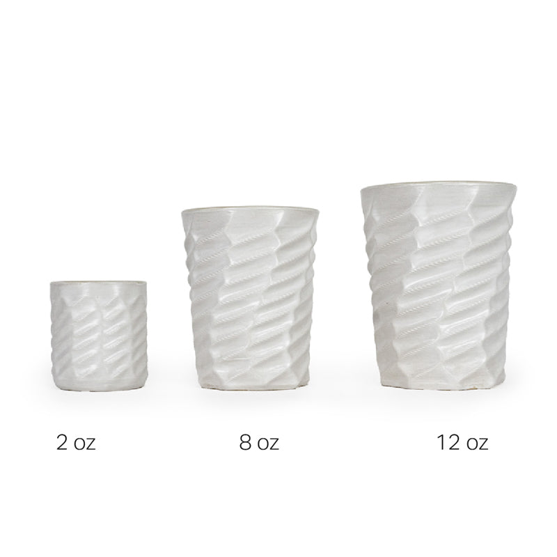 Three white textured 3D printed ceramic drinking cups with a wave twist pattern on a white background