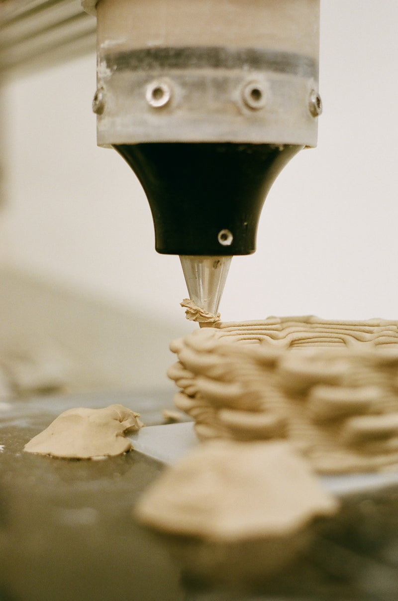 3D process printing process with a close-up of the nozzle and printed object.