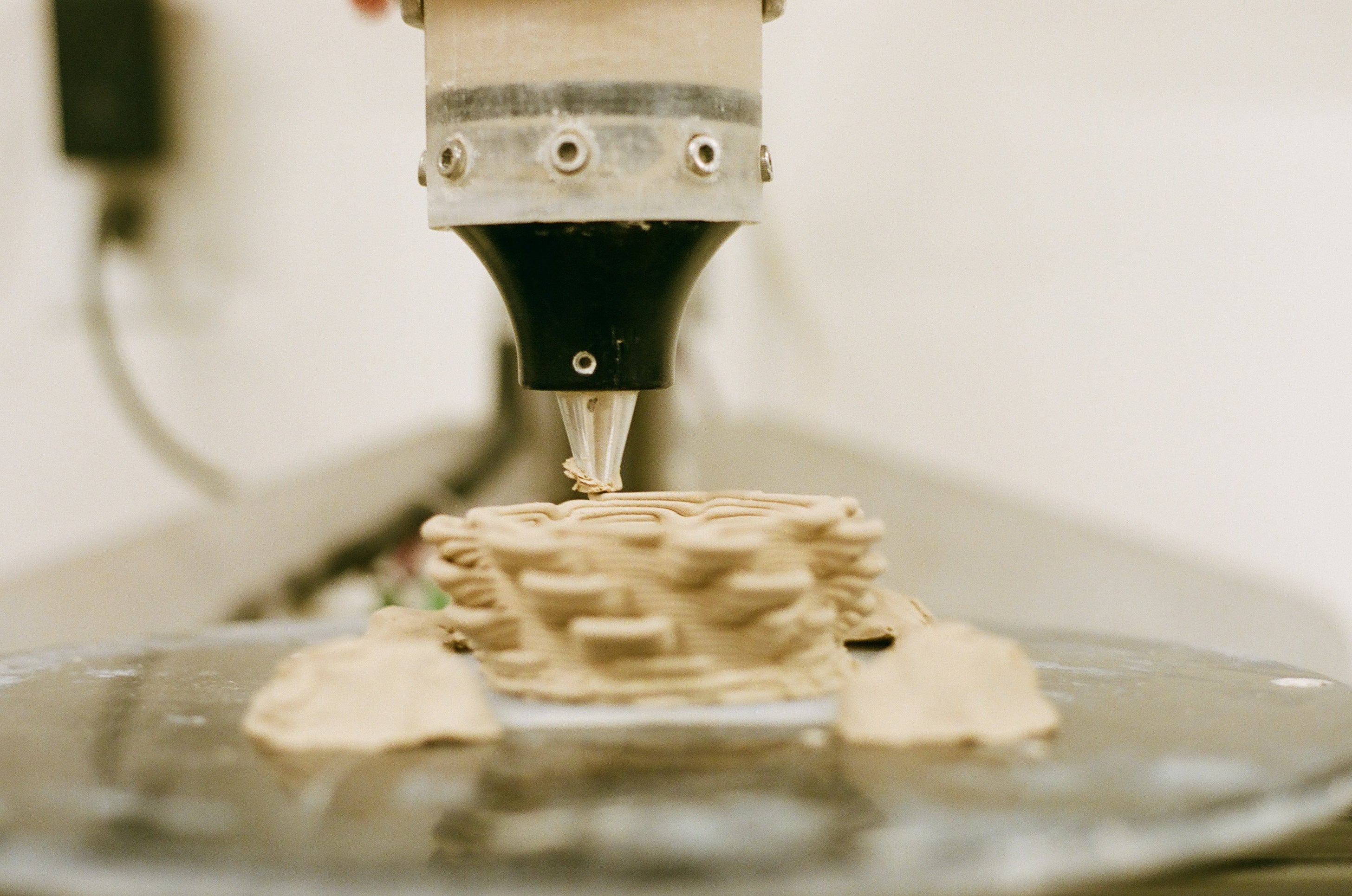 Close-up of a 3D clay printing machine tool in operation