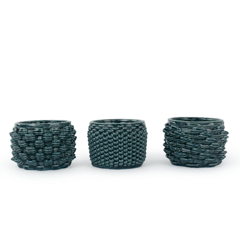 Three textured 3D printed ceramic cactus planters with different design patterns: loop, twist, and petal