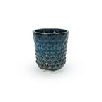 A textured blue 3D printed ceramic dot patterned chalice planters on a white background