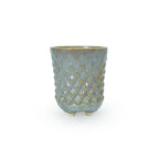 A textured light blue and gold 3D printed ceramic dot patterned chalice planters on a white background