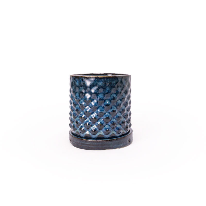 Sapphire float colored 3D printed ceramic planter with a dot pattern, with a tray on a white background