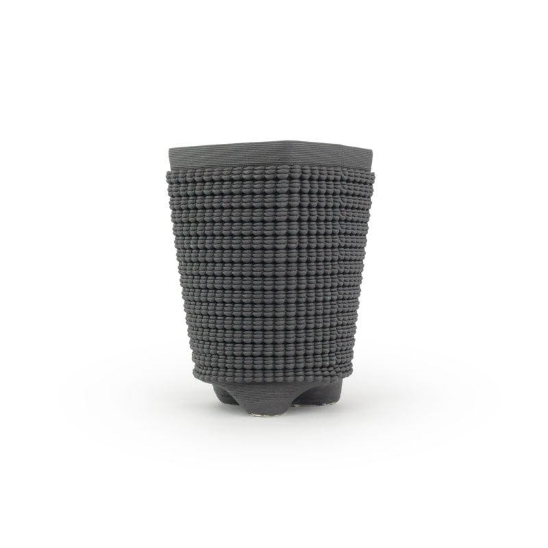 A black matte chalice 3D printed ceramic planter with a micro scallop pattern on a white background