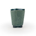 A green chalice 3D printed ceramic planter with a micro scallop pattern on a white background