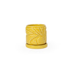 Marigold colored 3D printed ceramic planter with pixel paisley pattern, with a tray on a white background