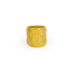 Marigold colored 3D printed ceramic planter with pixel paisley pattern on a white background