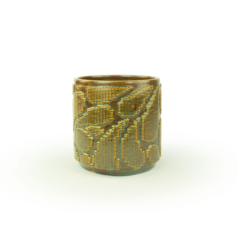 Iron lustre colored 3D printed ceramic planter with pixel paisley pattern on a white background