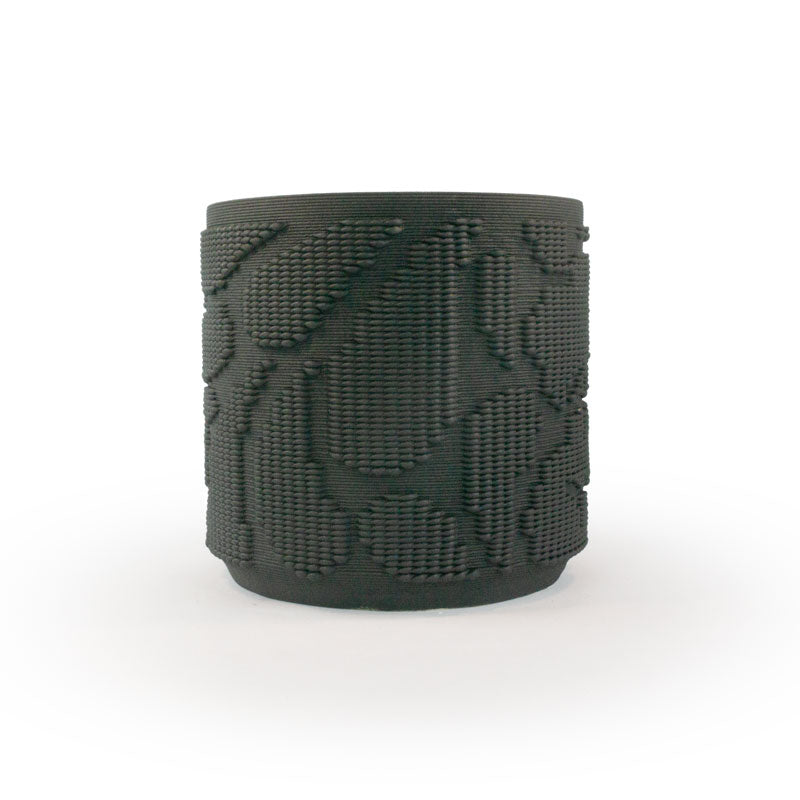 Matte black colored 3D printed ceramic planter with pixel paisley pattern on a white background