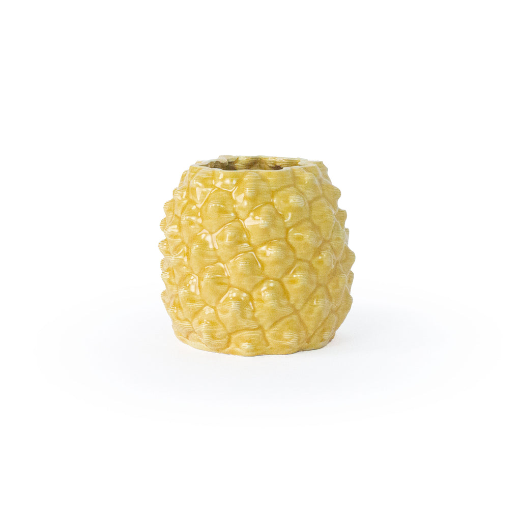 Marigold colored 3D printed ceramic planter with a pineapple pattern, on a white background
