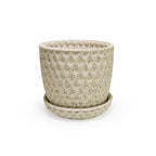 a close up of a 3D ceramic printed planter with a diamond pattern and speckles, with a tray