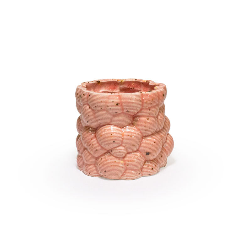 3D printed ceramic planter with a pink bubble pattern on a white background