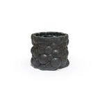 3D printed ceramic planter with a matte black bubble pattern on a white background