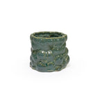 3D printed ceramic planter with a dark green bubble pattern on a white background