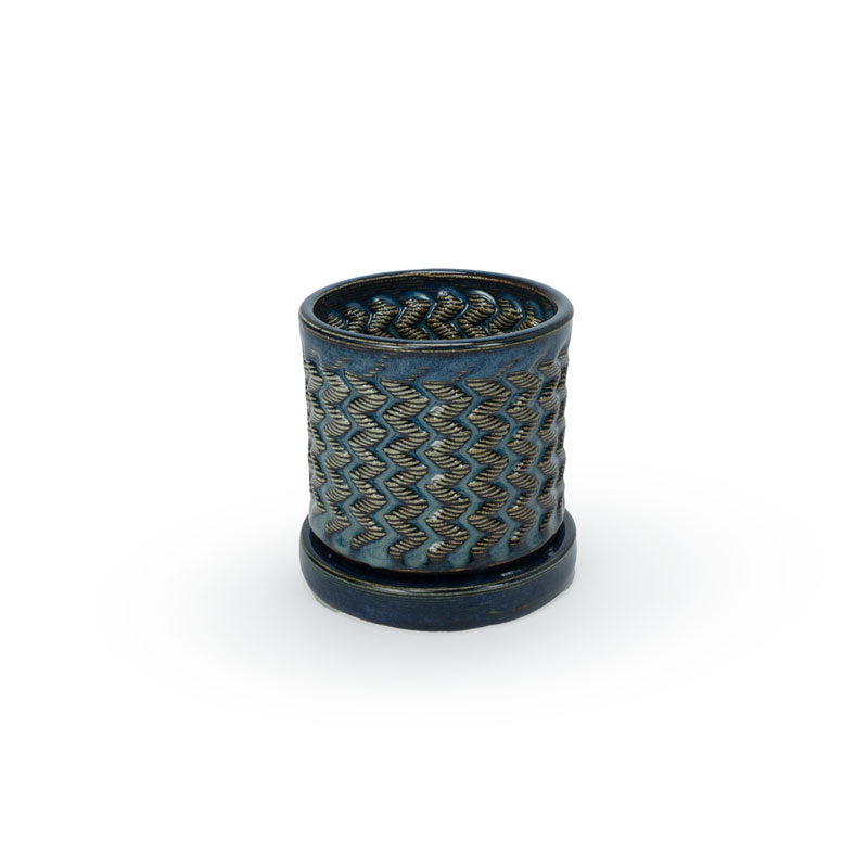 Sapphire float colored 3D printed ceramic planter with a zig zag pattern, on a tray, on a white background
