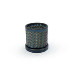 Sapphire float colored 3D printed ceramic planter with a zig zag pattern, on a tray, on a white background