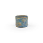 Blue rutile colored 3D printed  ceramic planter with a swirl pattern on a white background