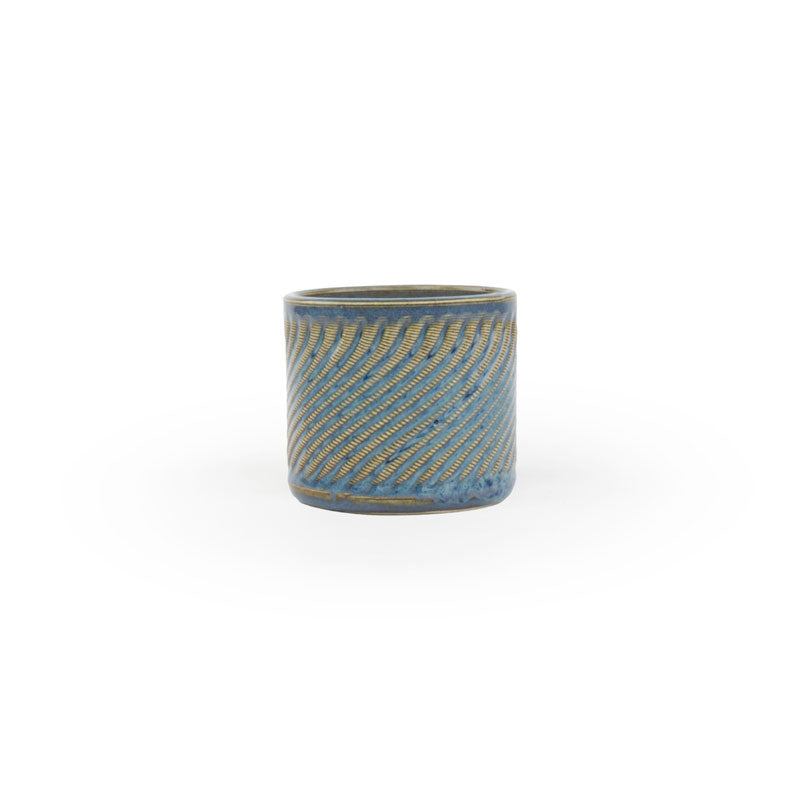 Blue rutile colored 3D printed  ceramic planter with a swirl pattern on a white background