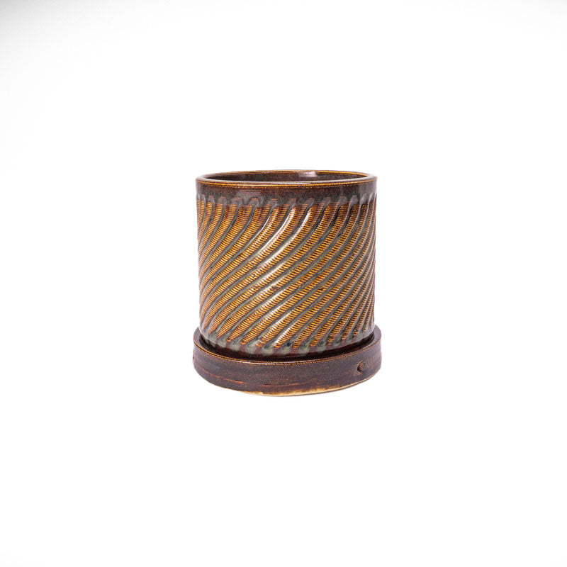 Iron lustre colored 3D printed ceramic planter with a swirl pattern on a white background, with tray