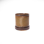 Iron lustre colored 3D printed ceramic planter with a swirl pattern on a white background, with tray