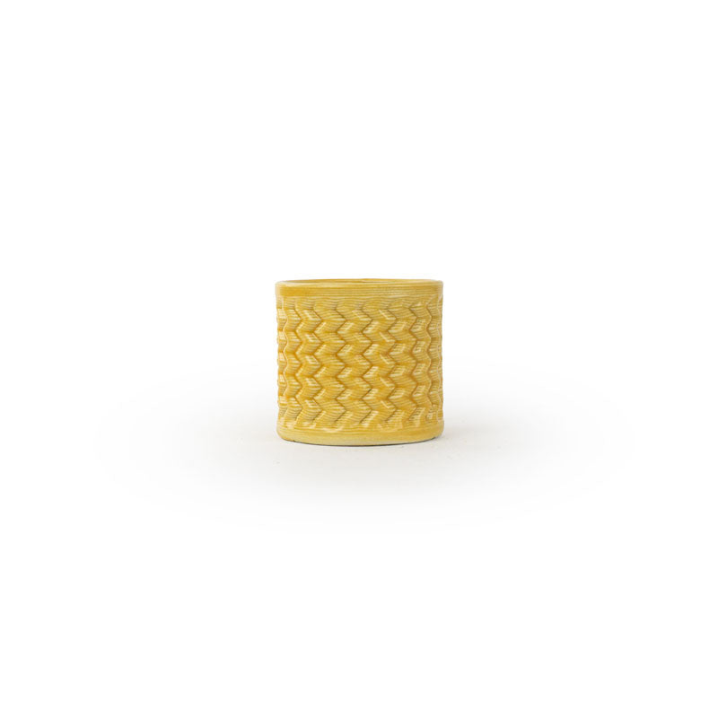 Marigold colored 3D printed ceramic planter with a zig zag pattern, on a white background