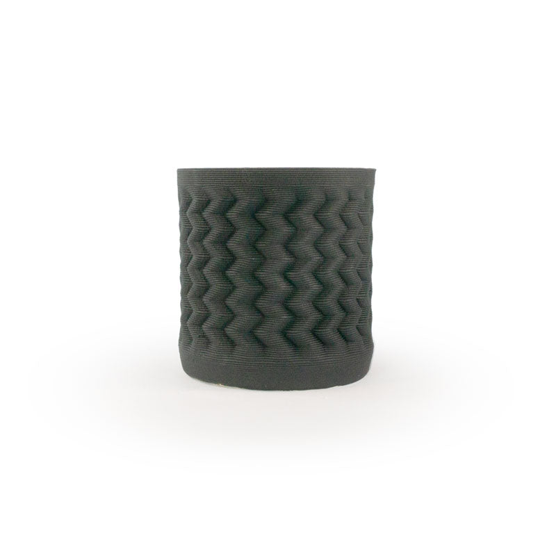 Matte black colored 3D printed ceramic planter with a zig zag pattern, on a white background