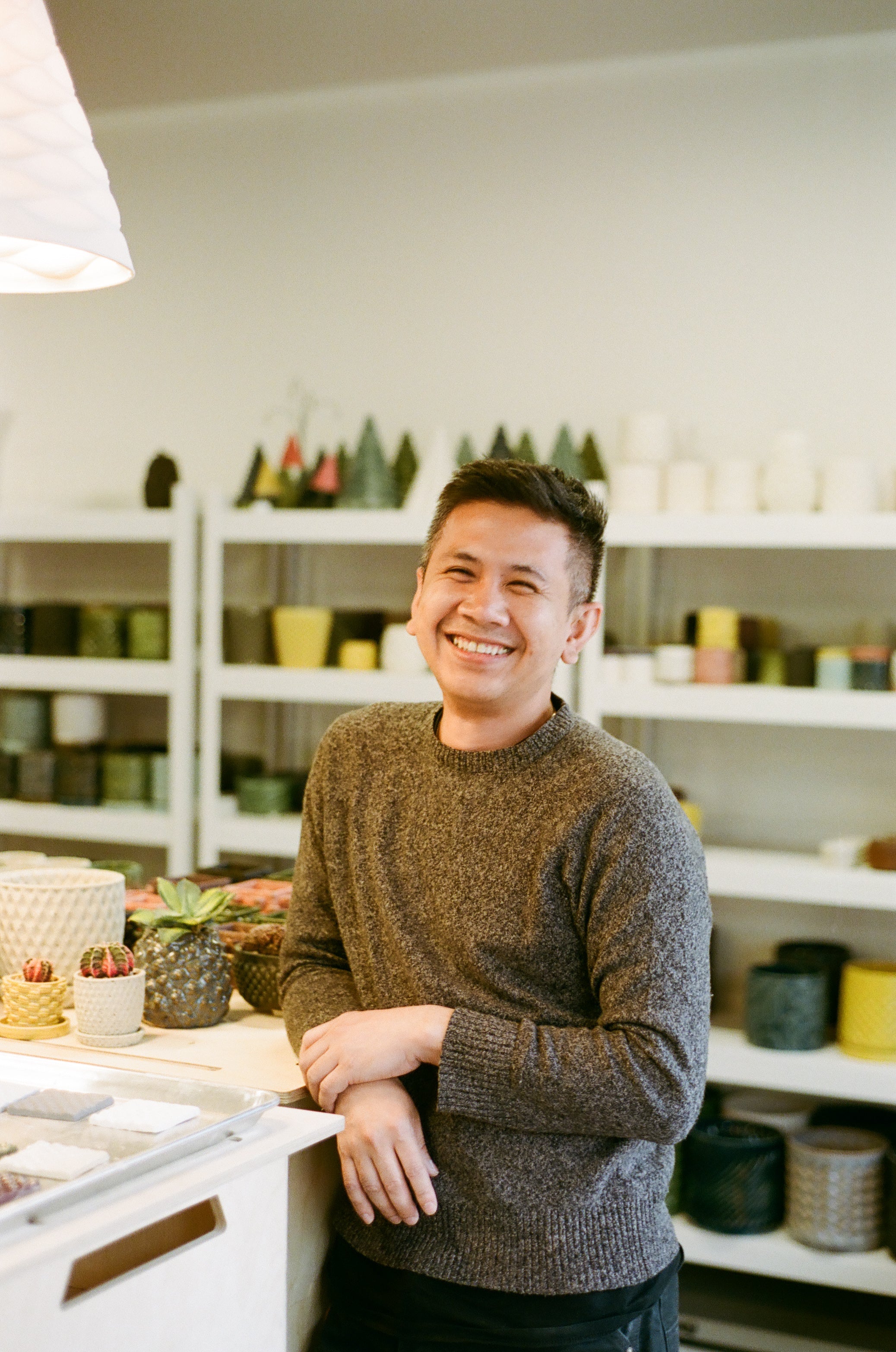 Man standing in a store with shelves of products in the background