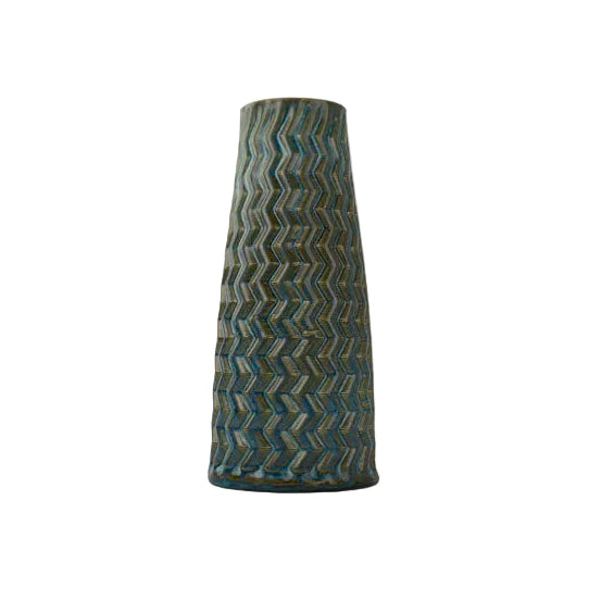 Tall blue rutile textured 3D printed ceramic vase with a zig zag taper, on a white background