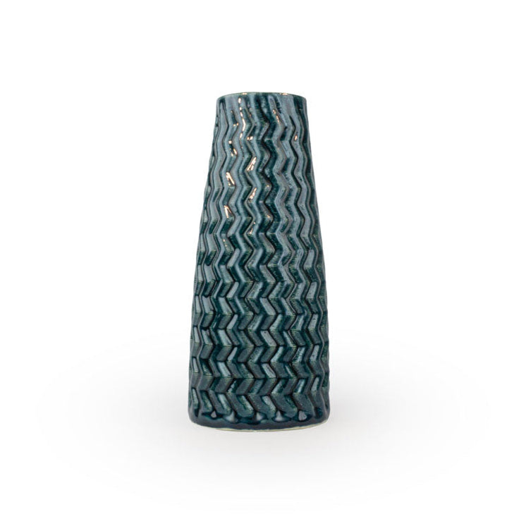 Tall storm textured 3D printed ceramic vase with a zig zag taper, on a white background